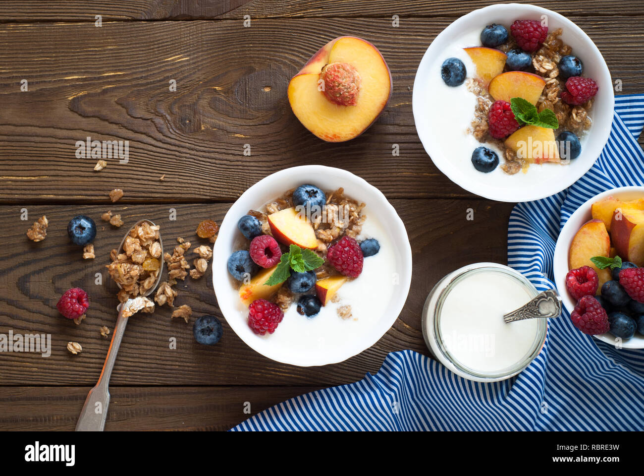 Yogurt with Granola  and fresh berries on  wooden table. Healthy breakfast. Stock Photo