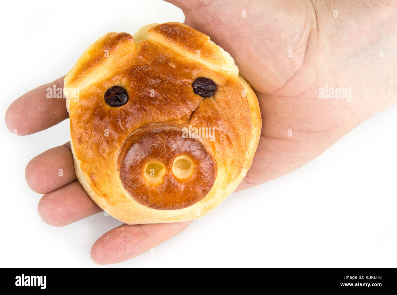 Bun with sweet stuffing in shape of pig head Stock Photo