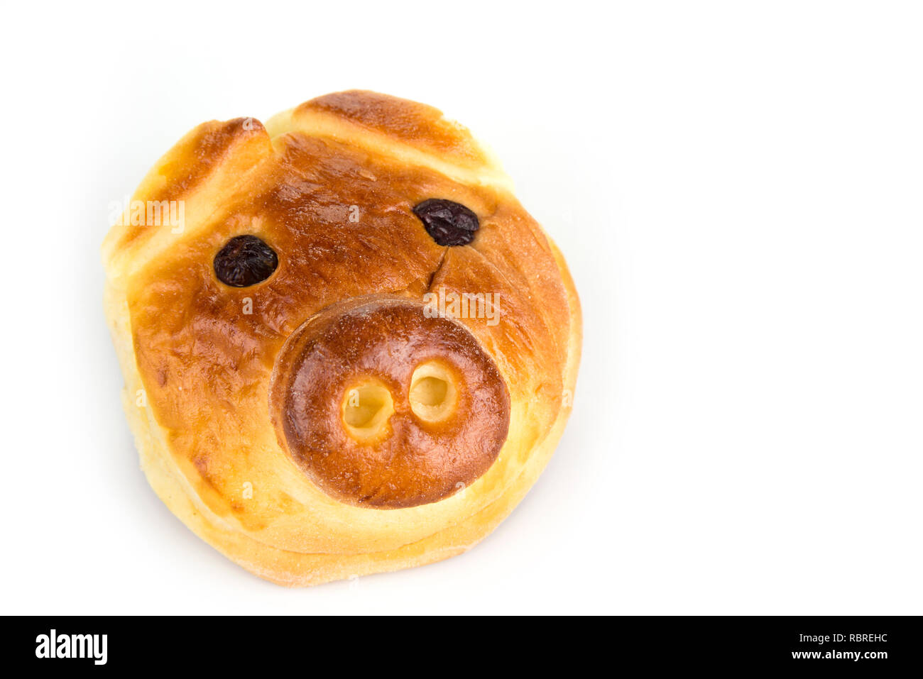 Bun with sweet stuffing in shape of pig head Stock Photo