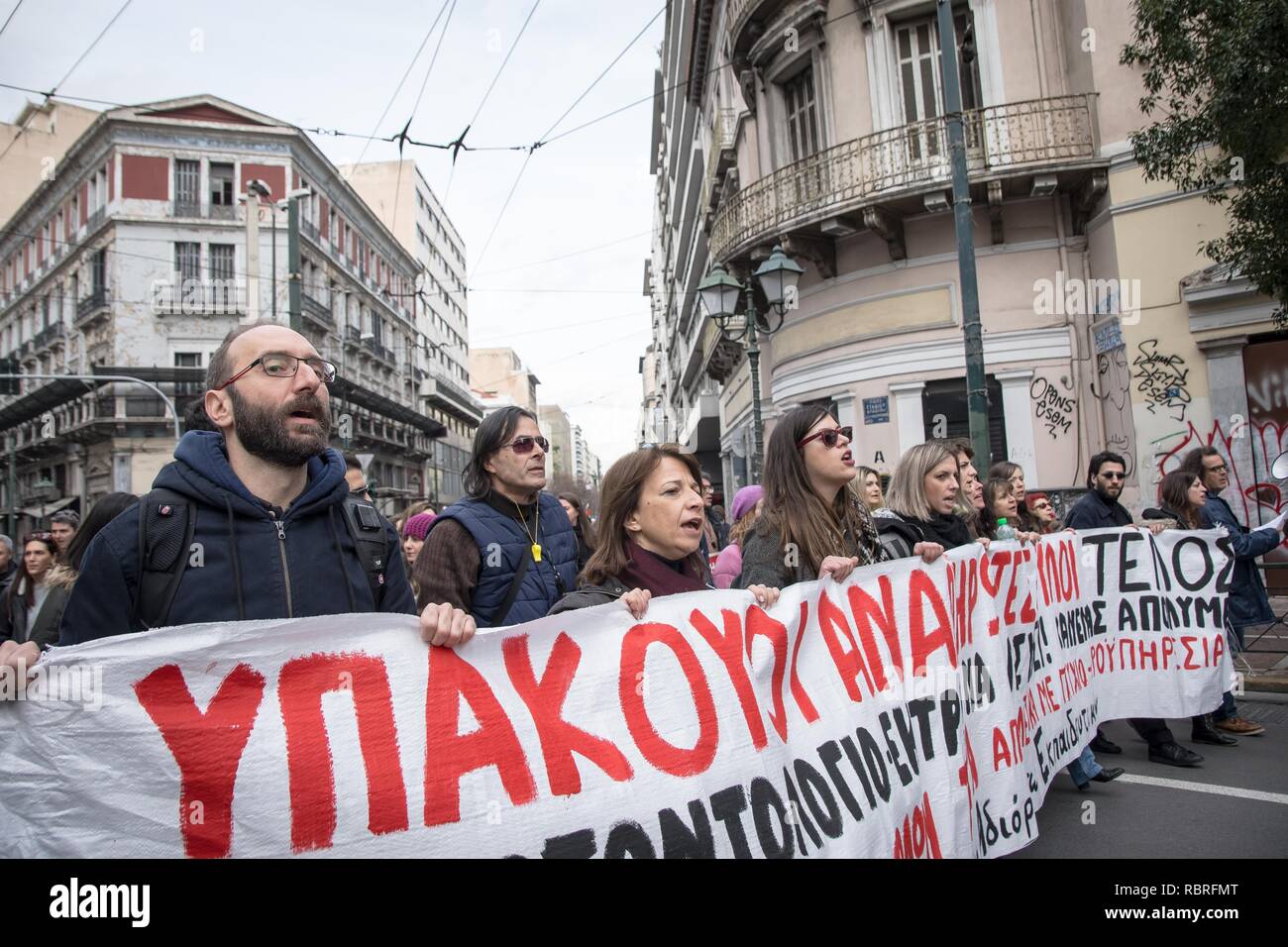 Protesters are seen holding a banner while chanting slogans during the demonstration. Thousands of people protest to withdraw the Ministry of Education's plan on the new system of the 15,000 recruits. Stock Photo