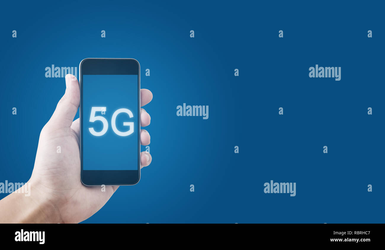 5G technology, Hand using 5g internet on mobile smartphone and on blue background Stock Photo