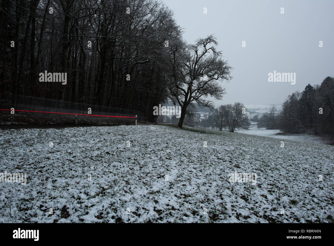 wintry road with light trails from cars Stock Photo