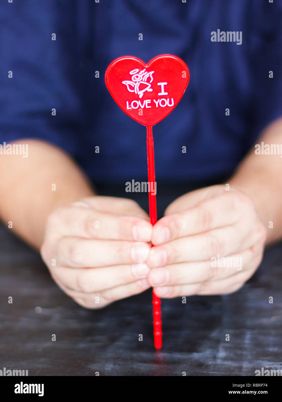 Man holds red heart with the words I love you in his hands Stock Photo ...