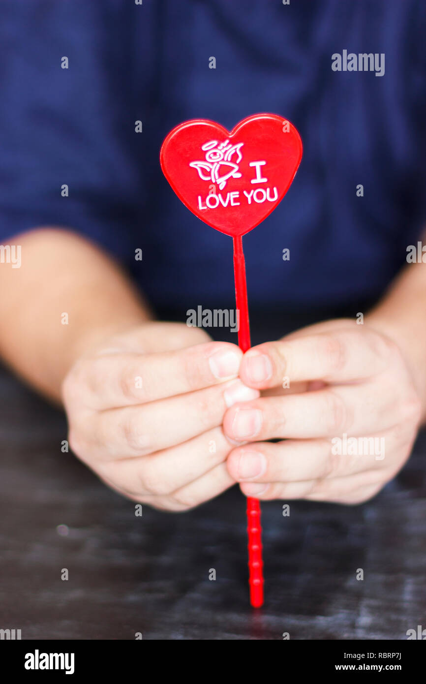Man holds red heart with the words I love you in his hands Stock Photo ...