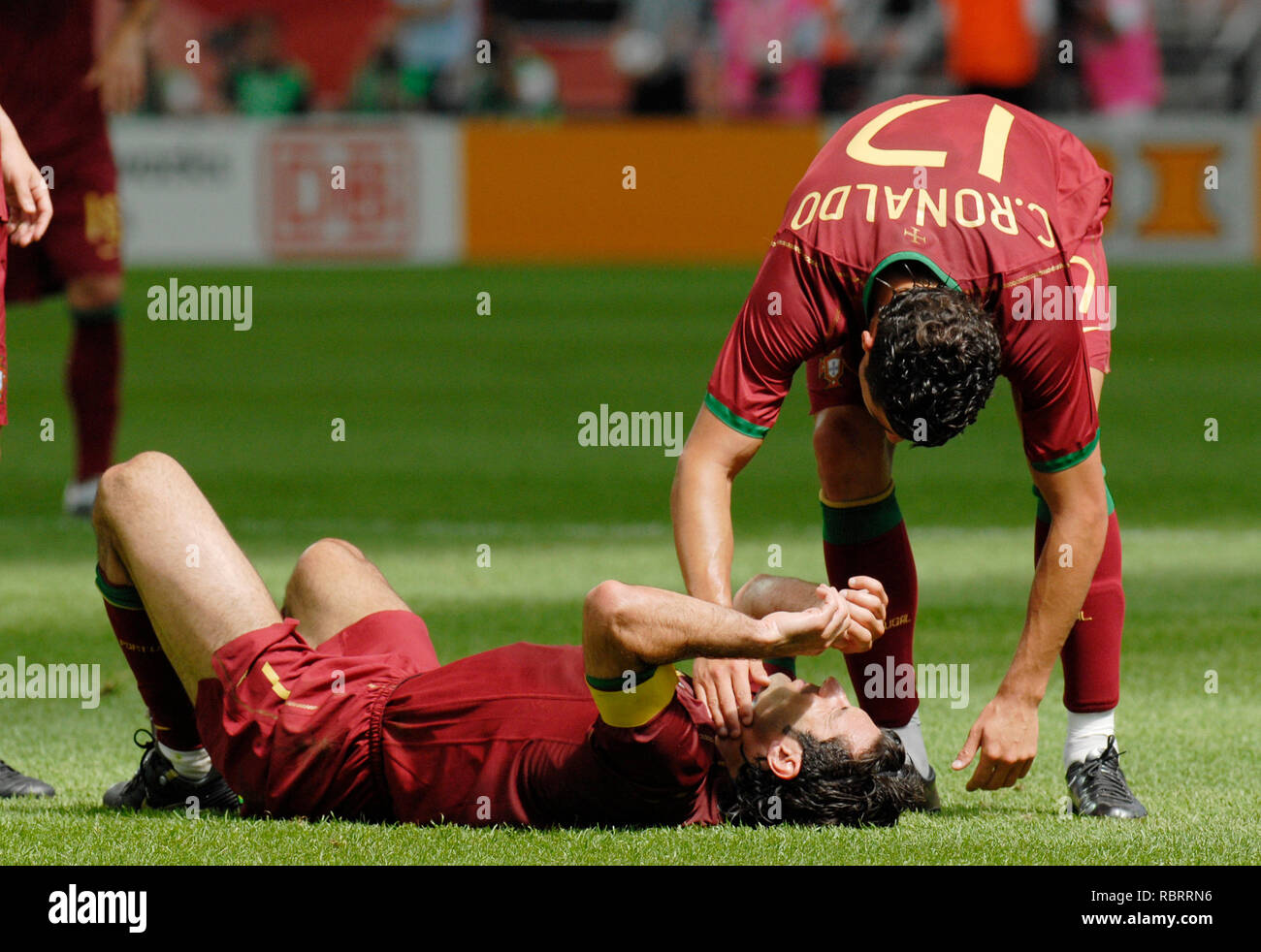 FIFA WM Stadion Frankfurt  Germany, 17.06.2006,  FIFA  World Cup Germany 2006  Portugal  vs Iran 2:0 --- Luis FIGO (POR) on the ground, Cristiano Ronaldo (POR) Stock Photo