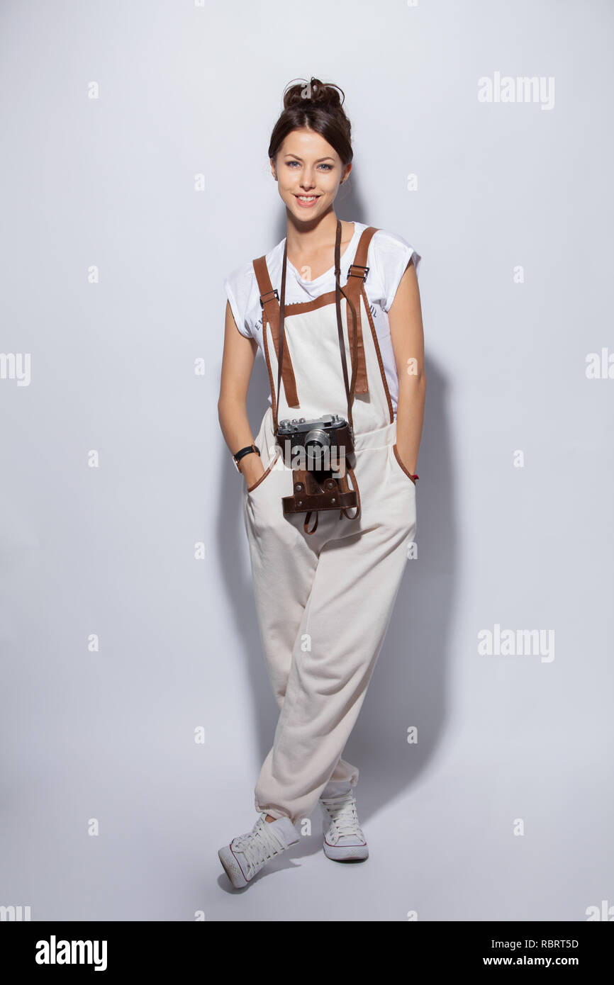 Full length portrait of a smiling casual woman standing on white ...