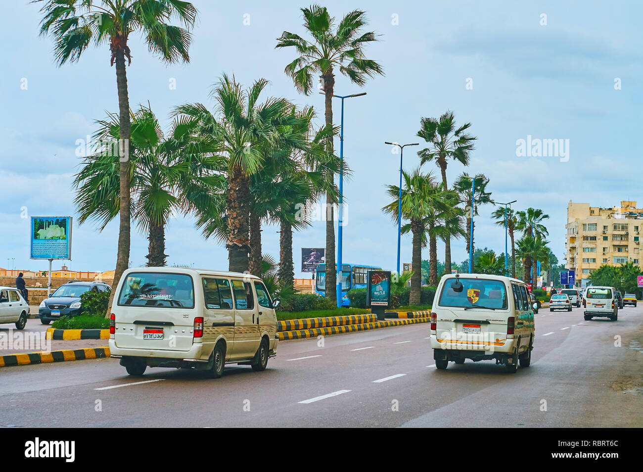 ALEXANDRIA, EGYPT - DECEMBER 19, 2017: The small microbuses drive along the Corniche Avenue, this type of public transport is popular and widely sprea Stock Photo