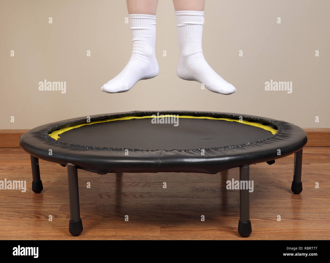 woman jumping on small trampoline showing feet and lower legs only Stock Photo