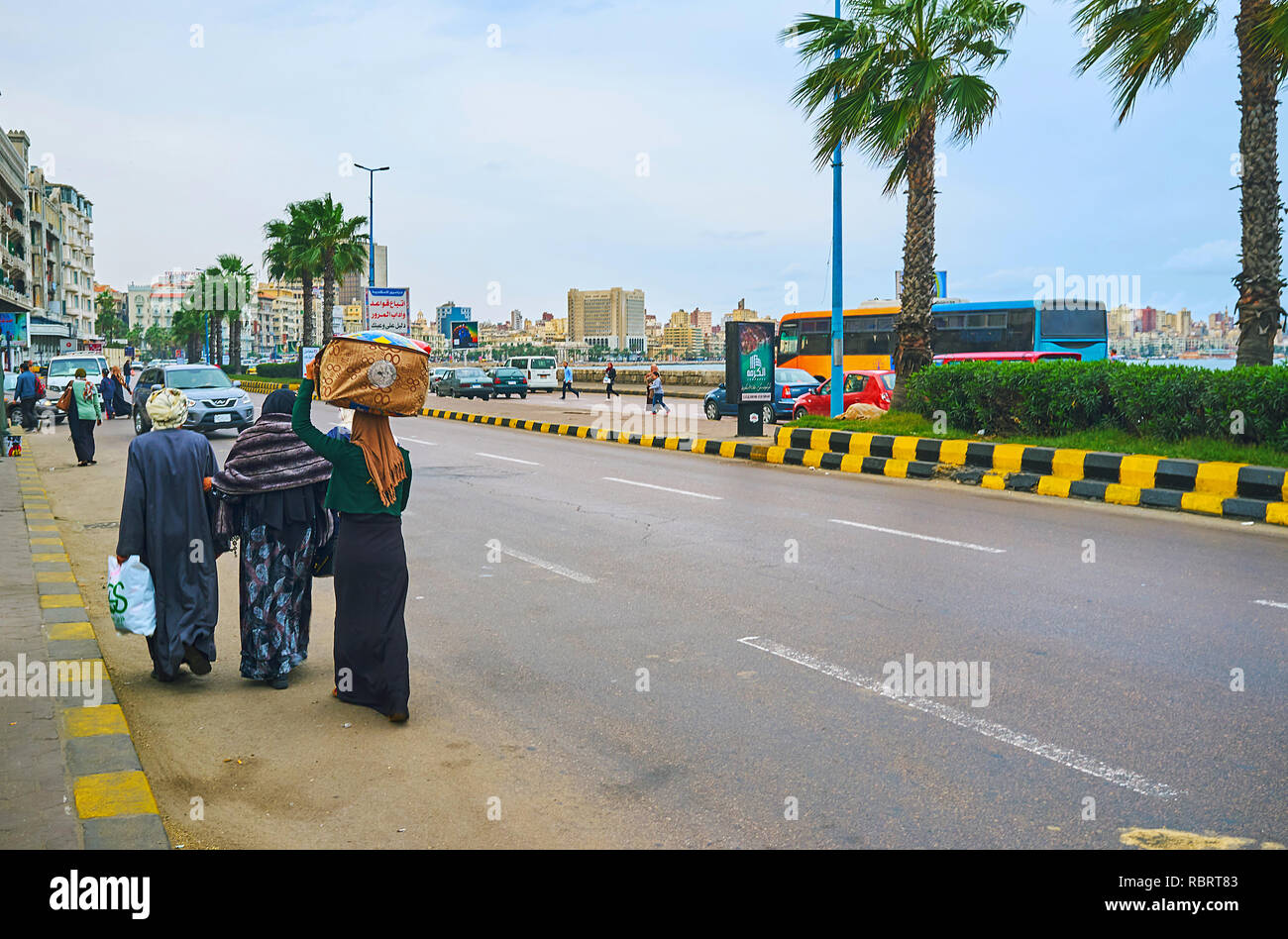 ALEXANDRIA, EGYPT - DECEMBER 19, 2017: Chaotic pedestrian movement along the road in Corniche Avenue, on December 19 in Alexandria. Stock Photo