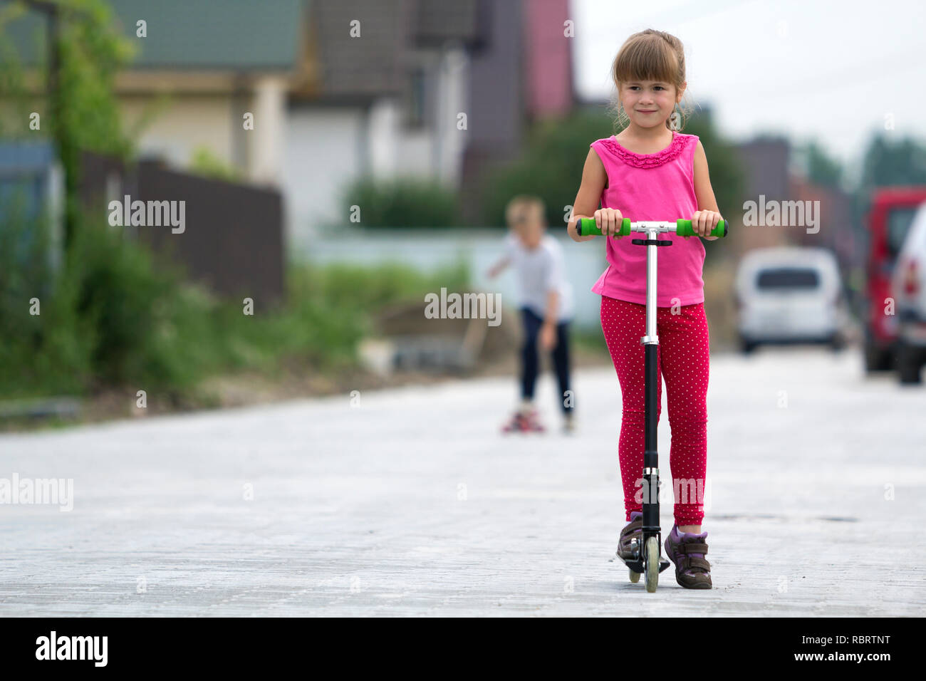 Pretty Young Long Haired Blond Child Girl In Pink Clothing With