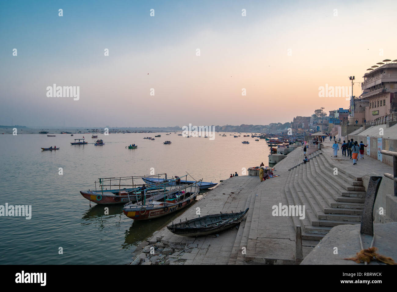 Boats at blue hour after sunset along the Ganges Ghat in Varanasi, India Stock Photo