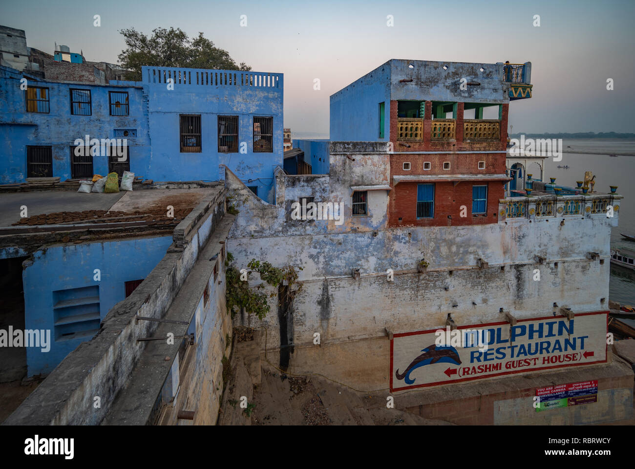 Old heritage buildings with some whitewashed blue in Varanasi, India at dusk after sunset. Stock Photo