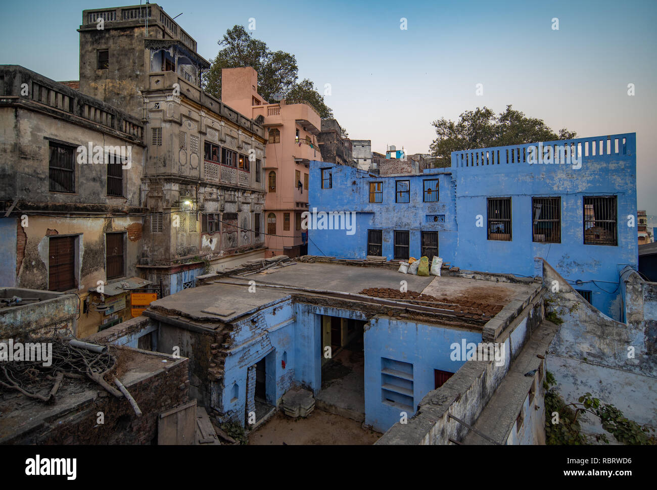Old heritage buildings with some whitewashed blue in Varanasi, India at dusk after sunset. Stock Photo