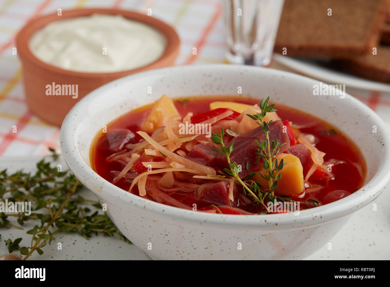 Borscht, the vegetable soup with beetroot, potato, cabbage, tomato, with garlic and thyme Stock Photo