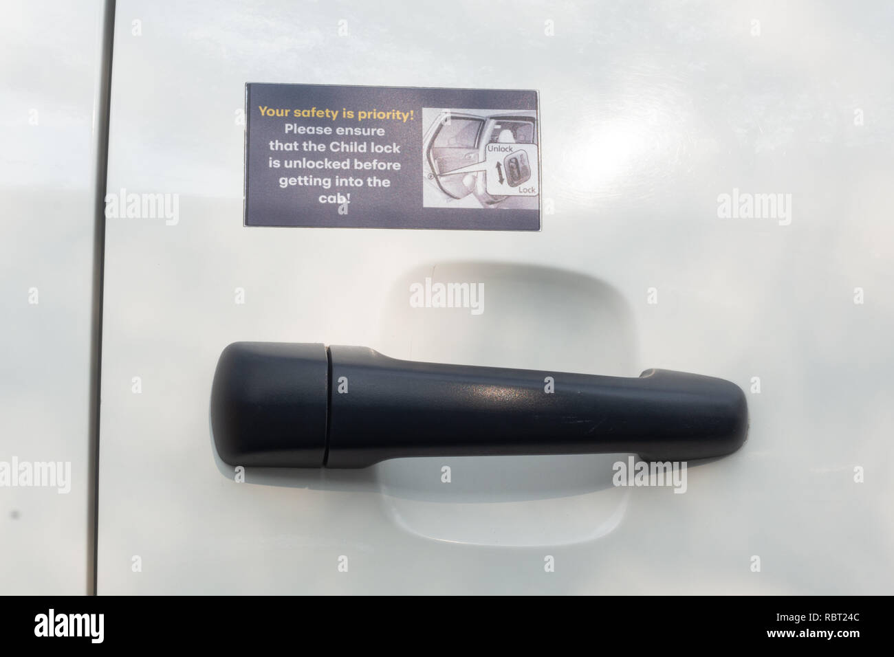 A Sticker With Child Safety Lock Instructions Pasted Above The Outside Door Handle Of A Car Stock Photo Alamy