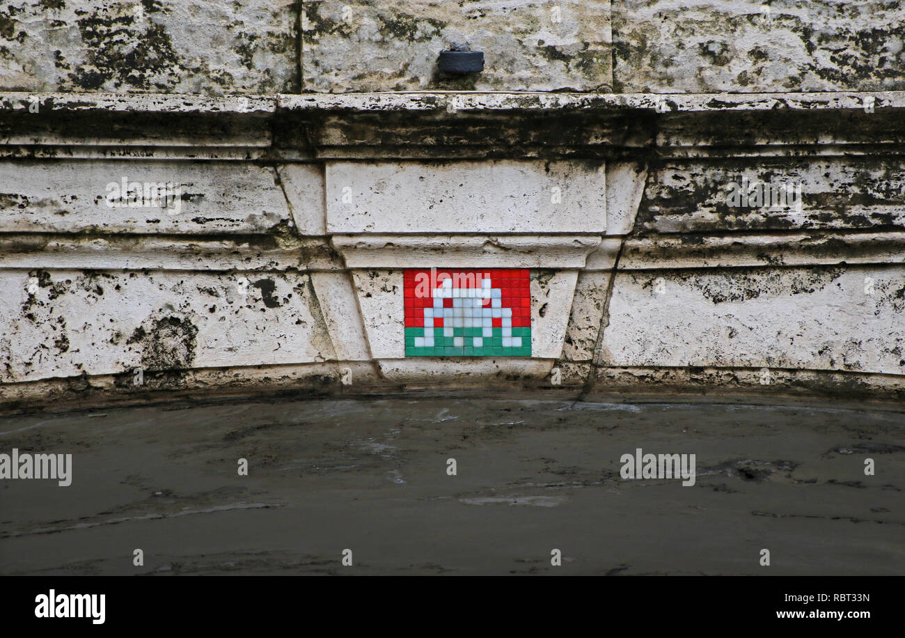 Invader art or space invader street mosaic on a bridge in Rome over Via Della Pilotta linking the Colonna Palace to the Quirinale Stock Photo