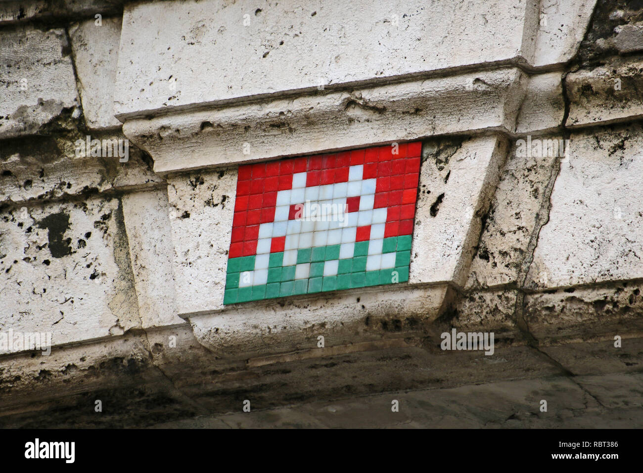 Invader art or space invader street mosaic on a bridge in Rome over Via Della Pilotta linking the Colonna Palace to the Quirinale Stock Photo