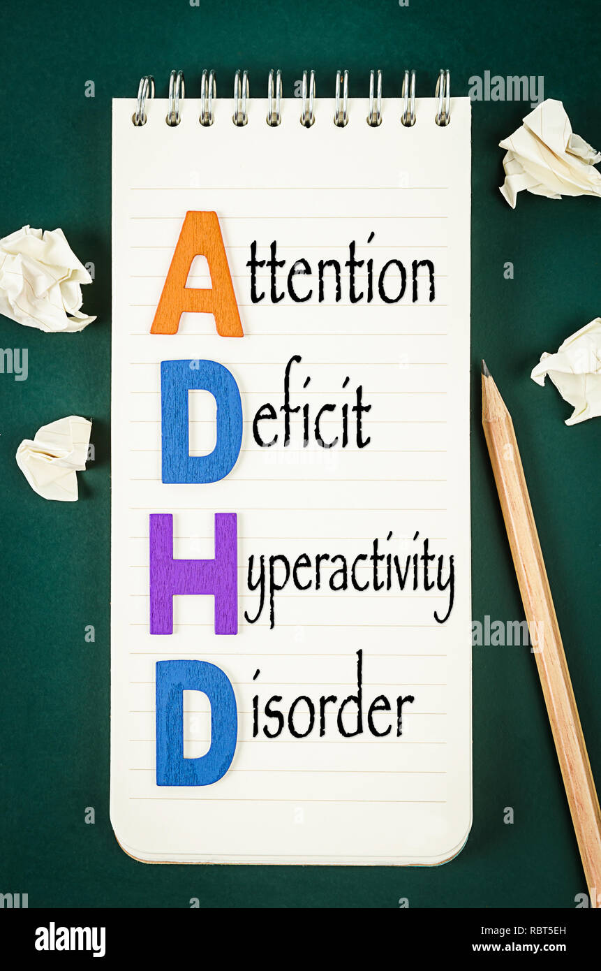 ADHD – attention deficit hyperactivity disorder concept on greenboard. Stock Photo