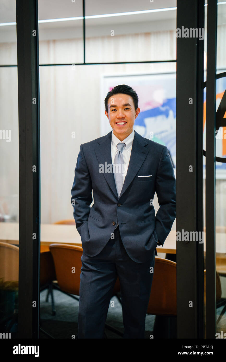 Portrait of a handsome, healthy and confident Asian business in a suit ...