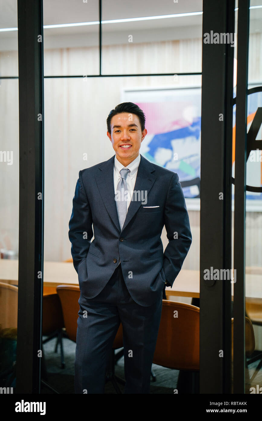 Portrait of a handsome, healthy and confident Asian business in a suit ...