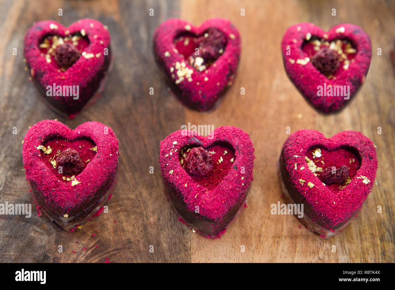 Six heart shaped Valentines day pink and red raspberry cookies Stock Photo