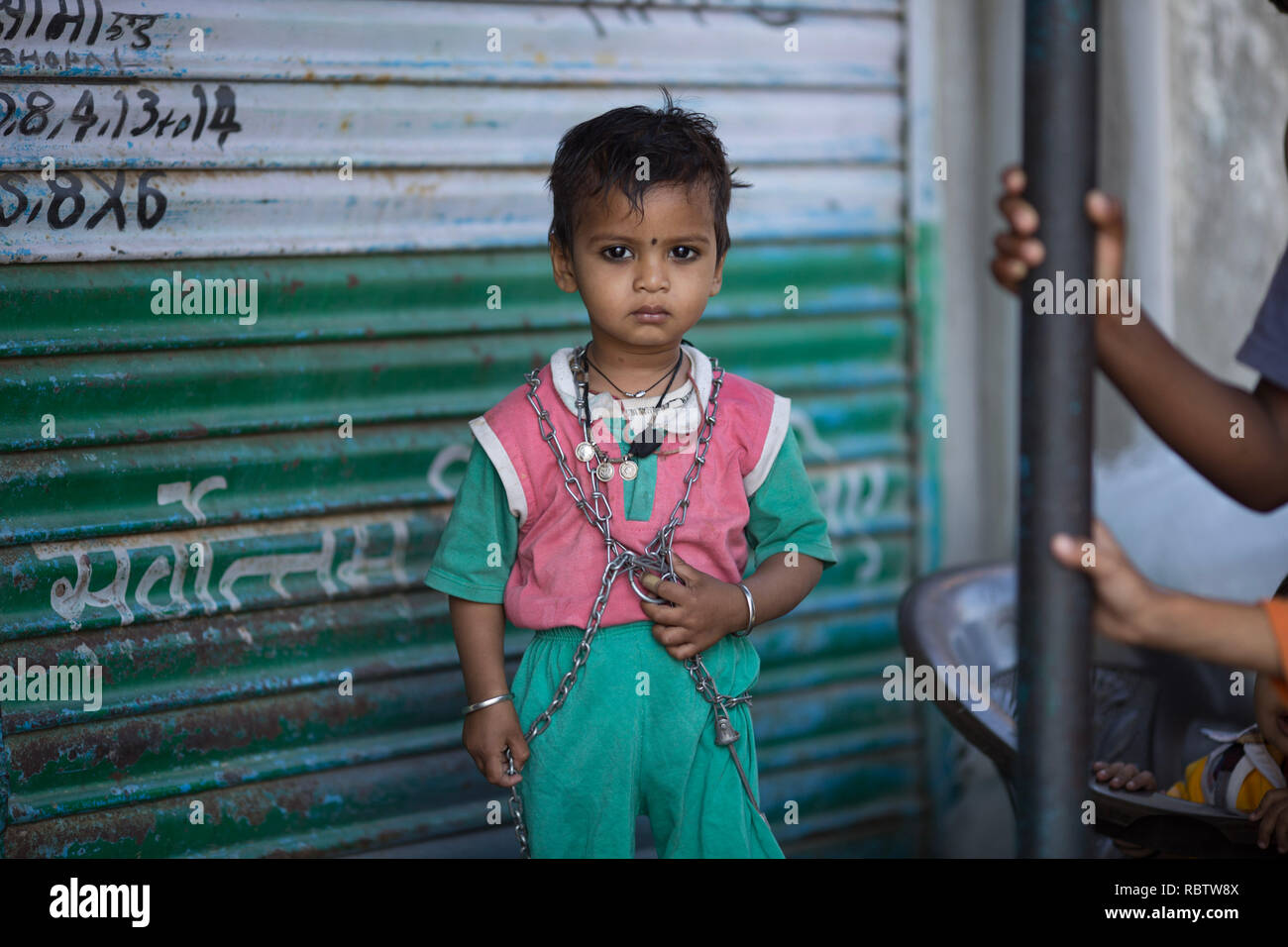 A local child seen posing for a photo near the derelict Union Carbide factory, Bhopal. The Bhopal Gas Disaster was a gas leak incident on the night of 2-3 December 1984 at the Union Carbide plant in Bhopal. Over 500,000 people were exposed to the toxic methyl isocyanate (MIC) gas as they slept. The final death toll is estimated to be between 15,000 and 20,000. Stock Photo
