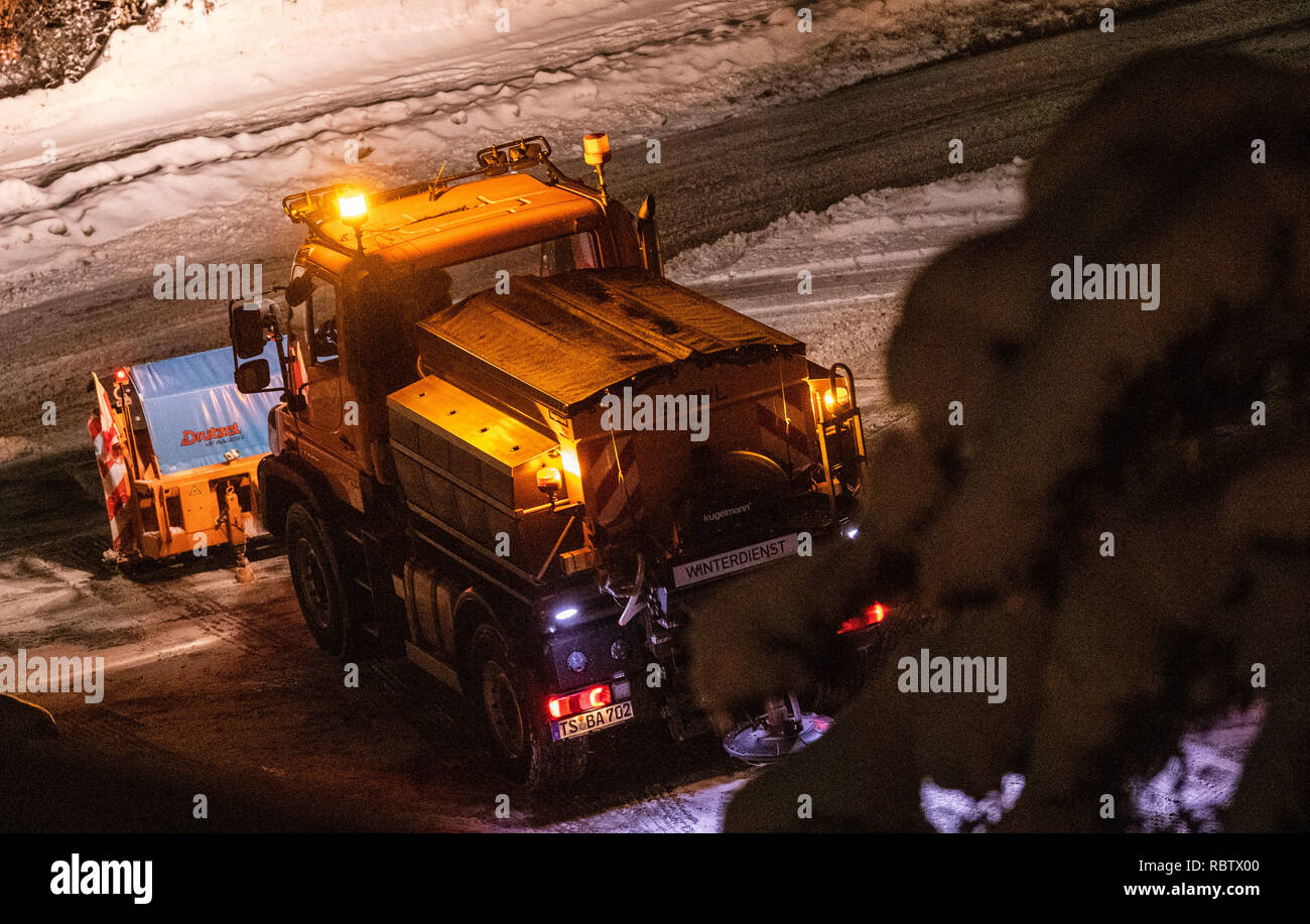 Berchtesgaden, Germany. 12th Jan, 2019. A snowplough is driving down a road. The heavy snowfalls of the past few days continue to keep the emergency forces in suspense in southern Bavaria and new snow is already approaching. According to the authorities, more than 1000 helpers have been deployed in the southern districts of Upper Bavaria. Credit: Lino Mirgeler/dpa/Alamy Live News Stock Photo