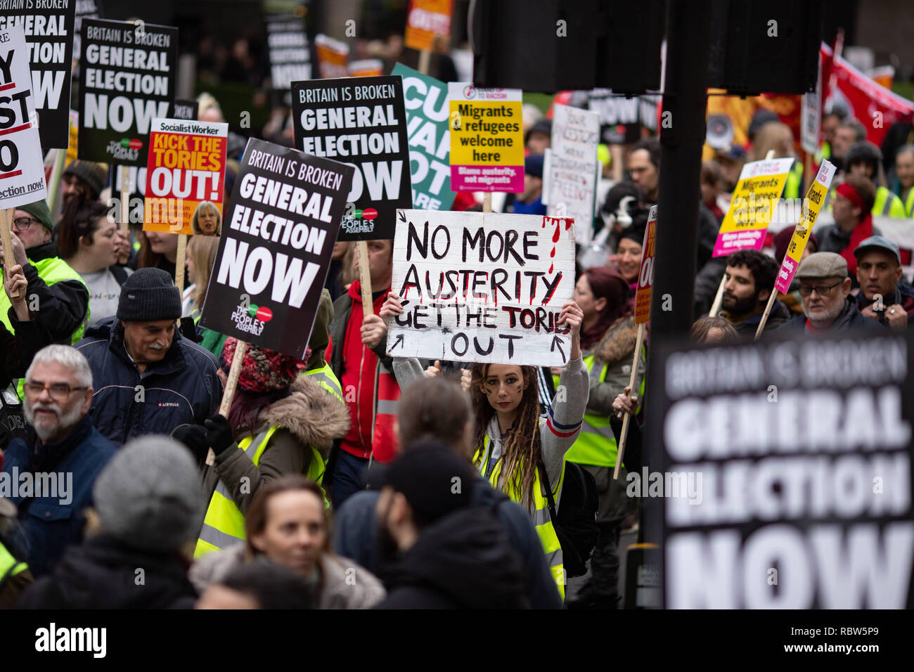 London, UK. 12th Jan, 2018. A demonstrator seen holding up a 'no more austerity, get the tories out' placard during the protest.Thousands rallied in central London for the 'People's Assembly against Austerity' inspired by the French 'Yellow Vest' protests bringing attention to austerity programs that have hit the poor hard. Credit: Ryan Ashcroft/SOPA Images/ZUMA Wire/Alamy Live News Stock Photo