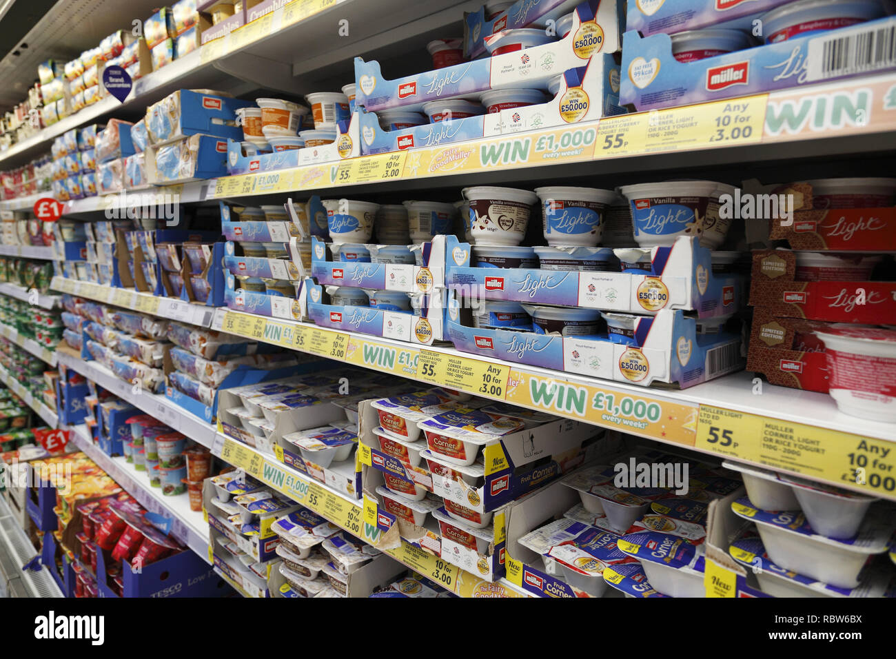 yogurt cups on a supermarket shelf UK Stock Photo