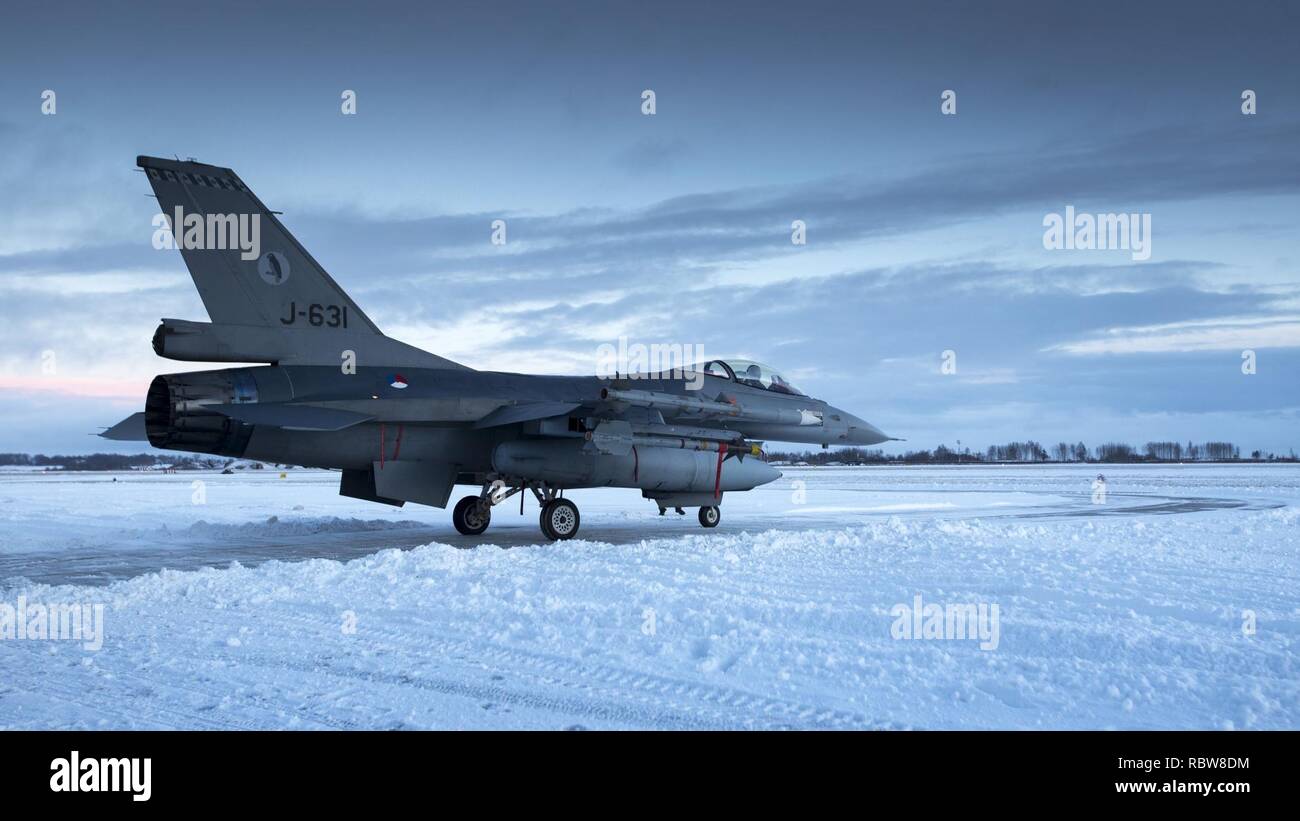 Litouwen, Siauliai, 4 januari 2017. BALTOPS. Nederland levert 4 F-16's ter verdediging van het luchtruim boven de Baltische staten. Foto: Een F-16 vertrekt, over een sneeuwvrij gemaakte baan, richting zijn nieuwe lokatie. A Dutch F-16 taxies at the Siauliai military base in Lithuania. Stock Photo