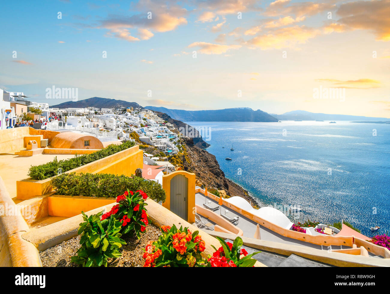 A picturesque scenic view of the Santorini caldera and the Aegean Sea from a resort terrace in the hillside village of Oia, Greece. Stock Photo