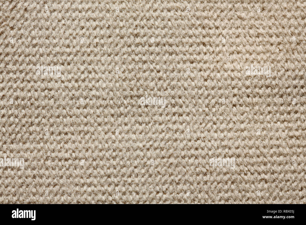 Knitted light brown textile background on macro. Stock Photo