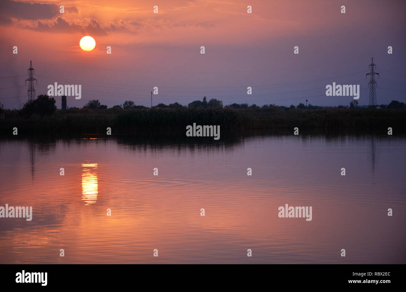 Amazing sunset sky in the evening and sunlight reflection on water ...