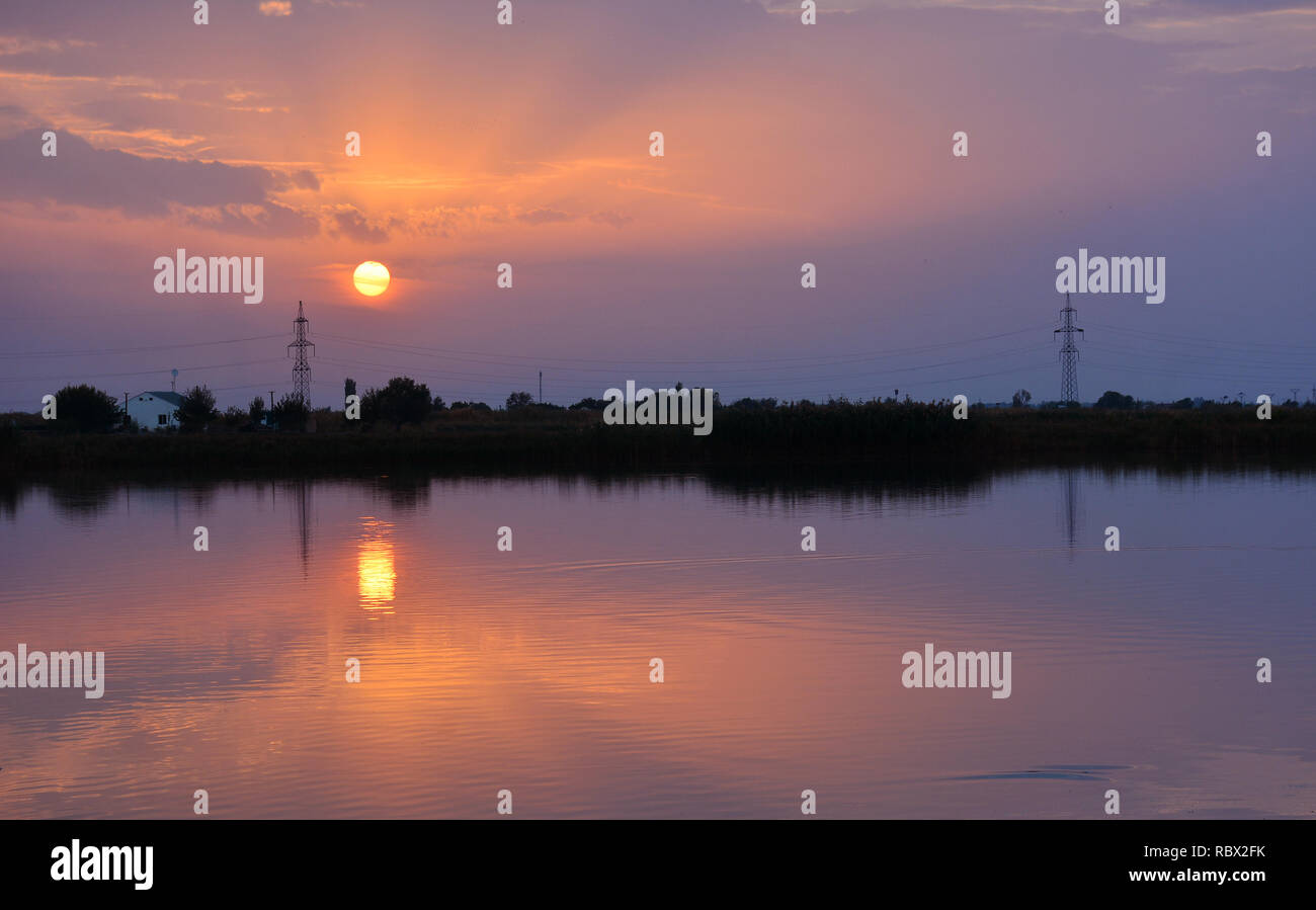 Amazing sunset sky in the evening and sunlight reflection on water ...