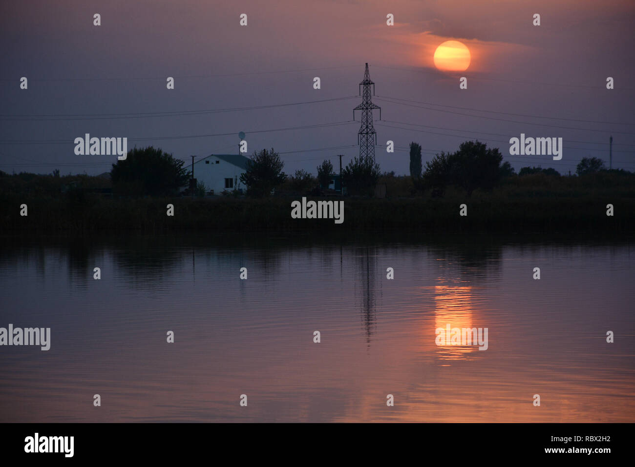 Amazing sunset sky in the evening and sunlight reflection on water ...