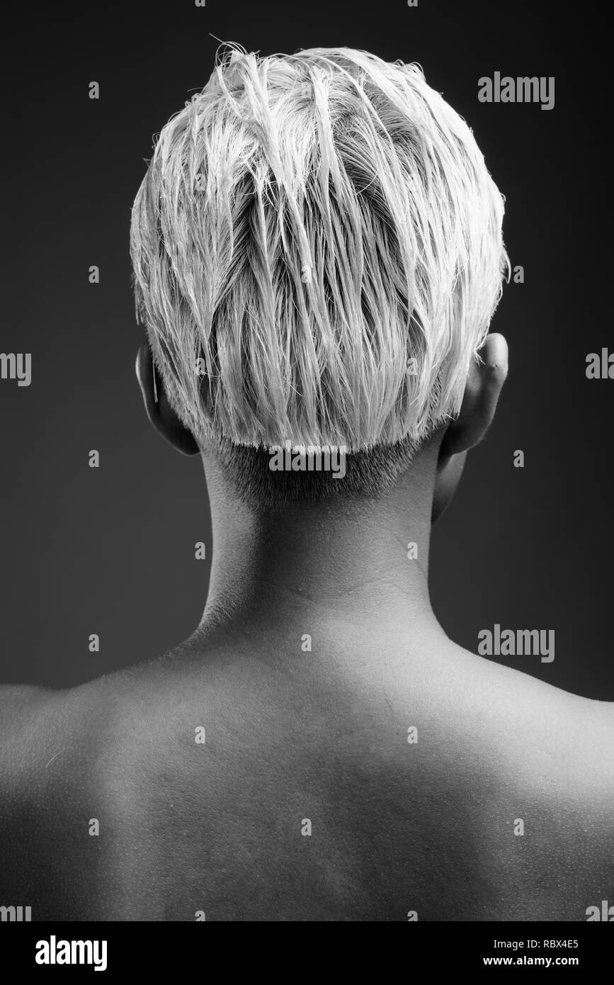 Young Beautiful Rebellious Woman With Short Hair Against Gray Ba