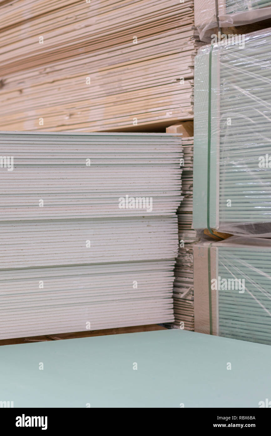 Gypsum plasterboard in the pack. The stack of gypsum board preparing