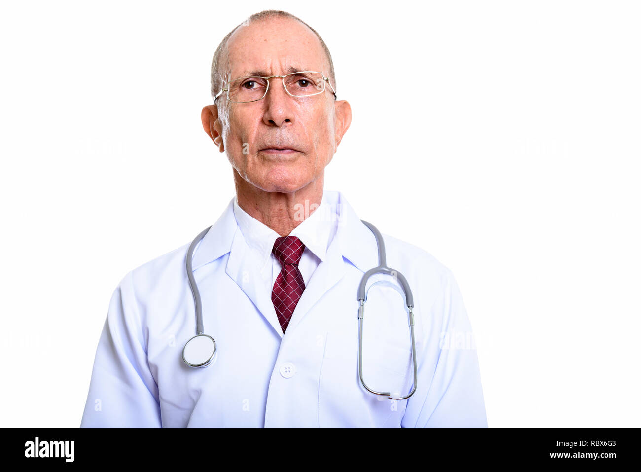 Studio shot of senior man doctor isolated against white background Stock Photo