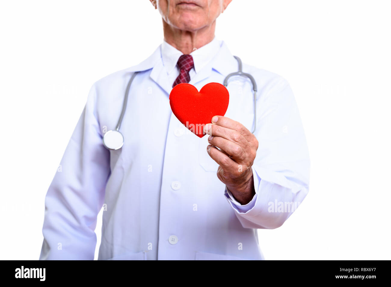 Senior man doctor holding red heart isolated against white background Stock Photo