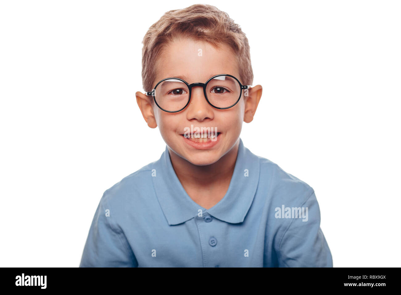 cucasian boy ajusting his eyeglasses and looking at camera over white background. Concept new eyeglasses for good vision Stock Photo