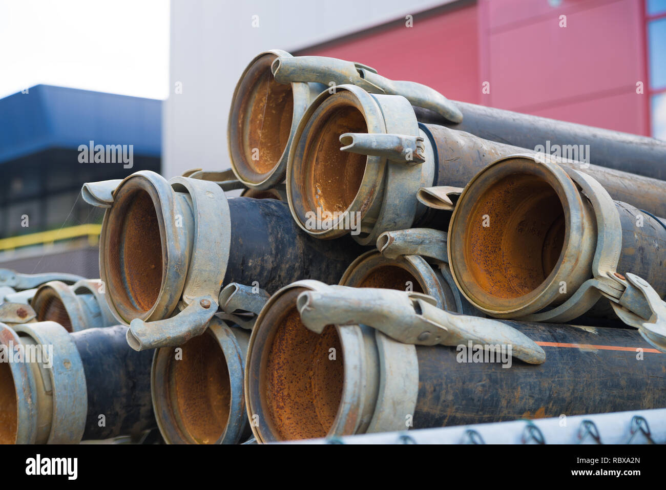 piled up irrigation pipes with clamps Stock Photo Alamy
