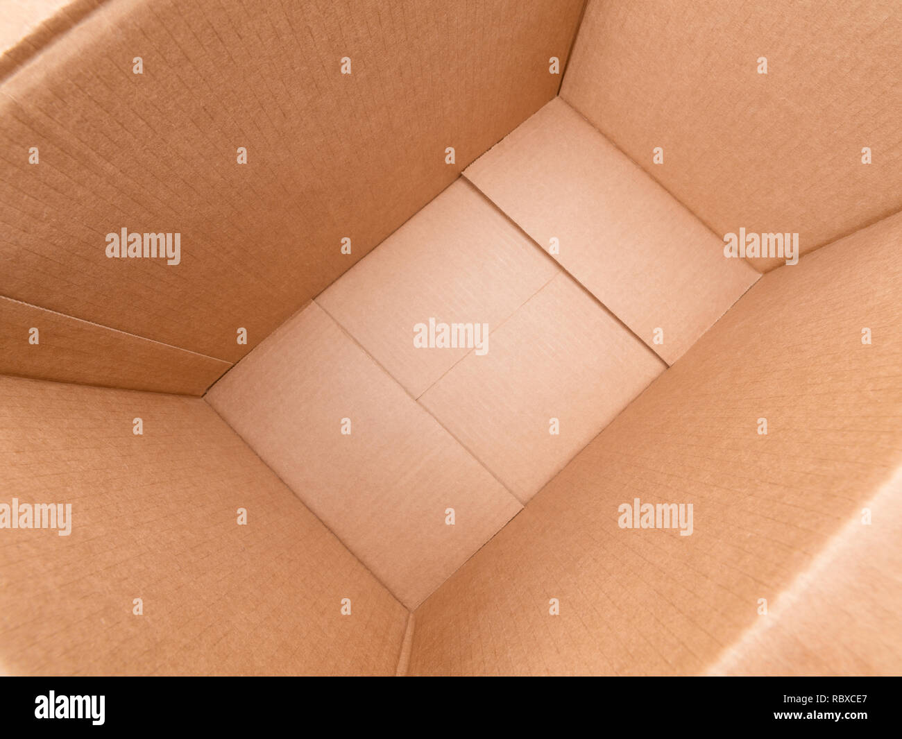 Wide angle diagonal view inside large rough cardboard box Stock Photo