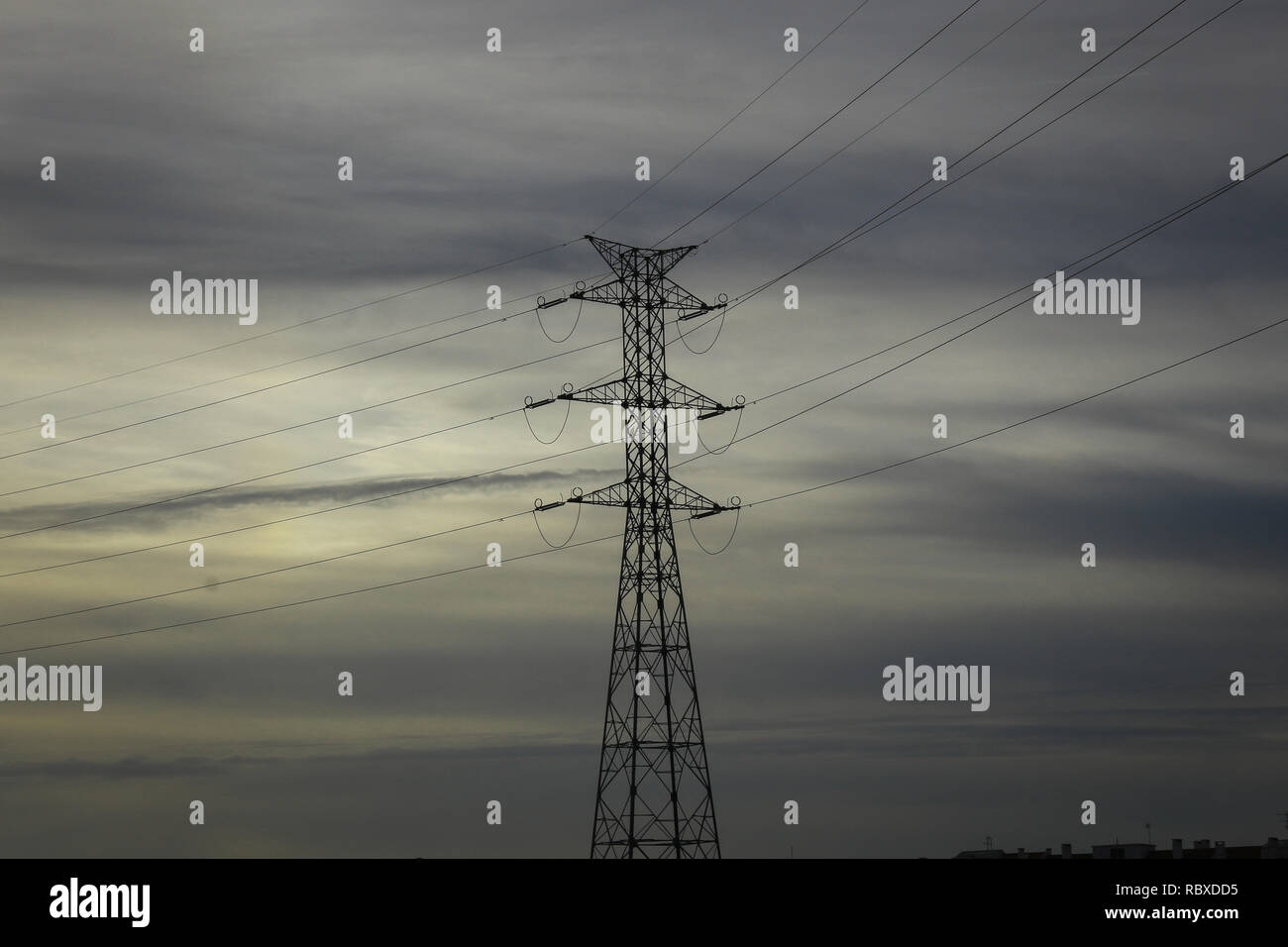 High-voltage power transmission towers in sunset sky background Stock ...
