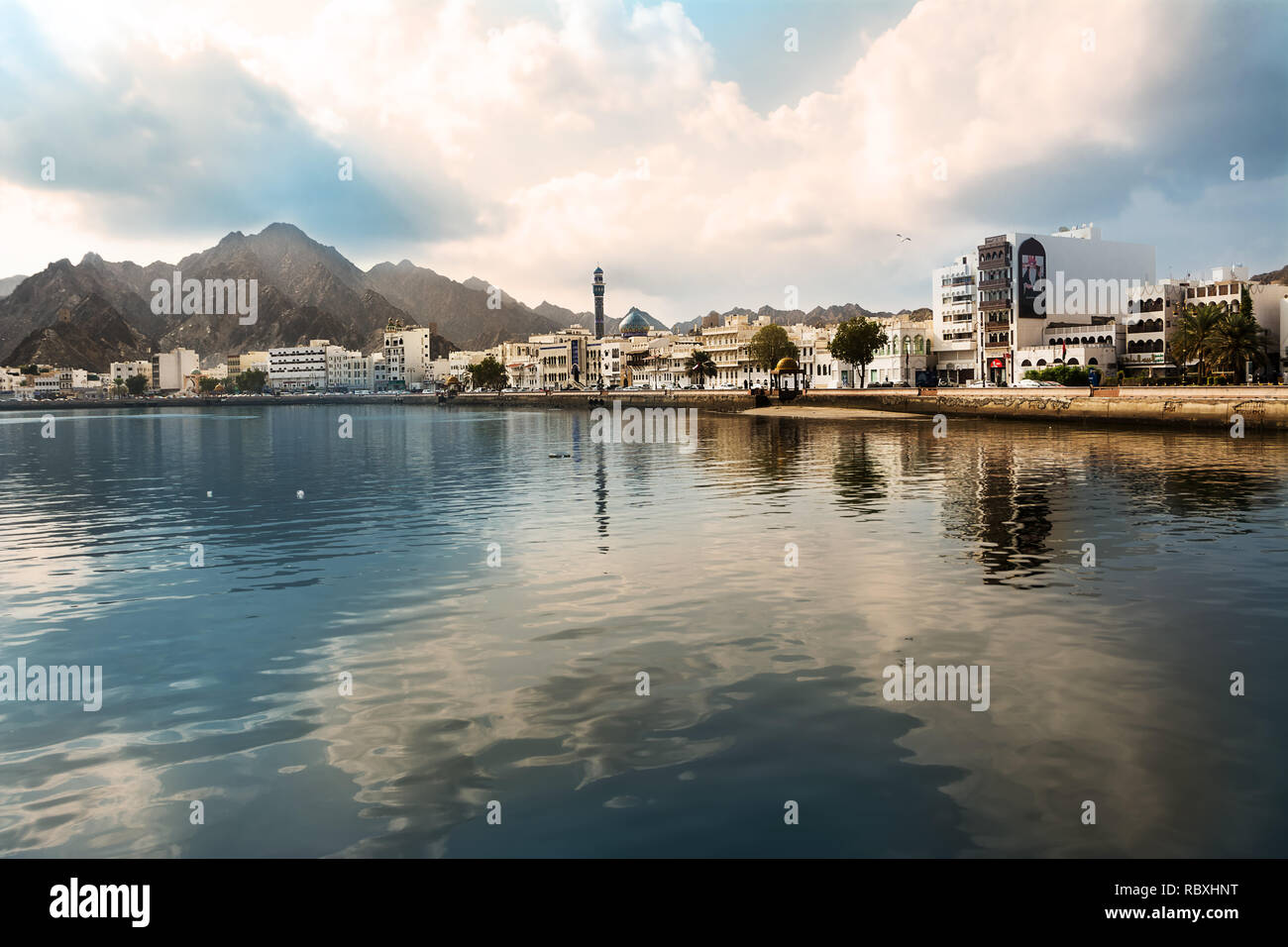 Muscat, Oman - November 1, 2018: Mutrah waterfront in Muscat at sunset and reflected on the bay with nobody Stock Photo