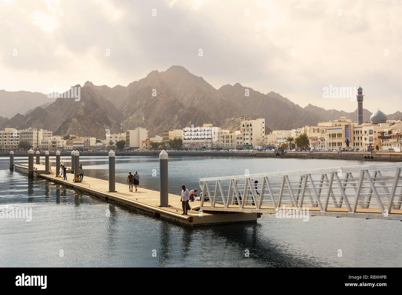 Muscat, Oman - November 1, 2018: Port dock at Mutrah of Muscat with tourists and fishermen and in the background Corniche of Mutrah Stock Photo