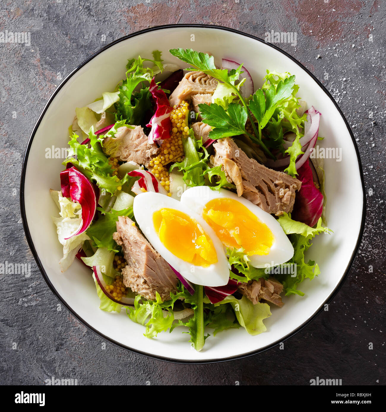 Diet food tuna salad with boiled egg, canned fish, onion and green
