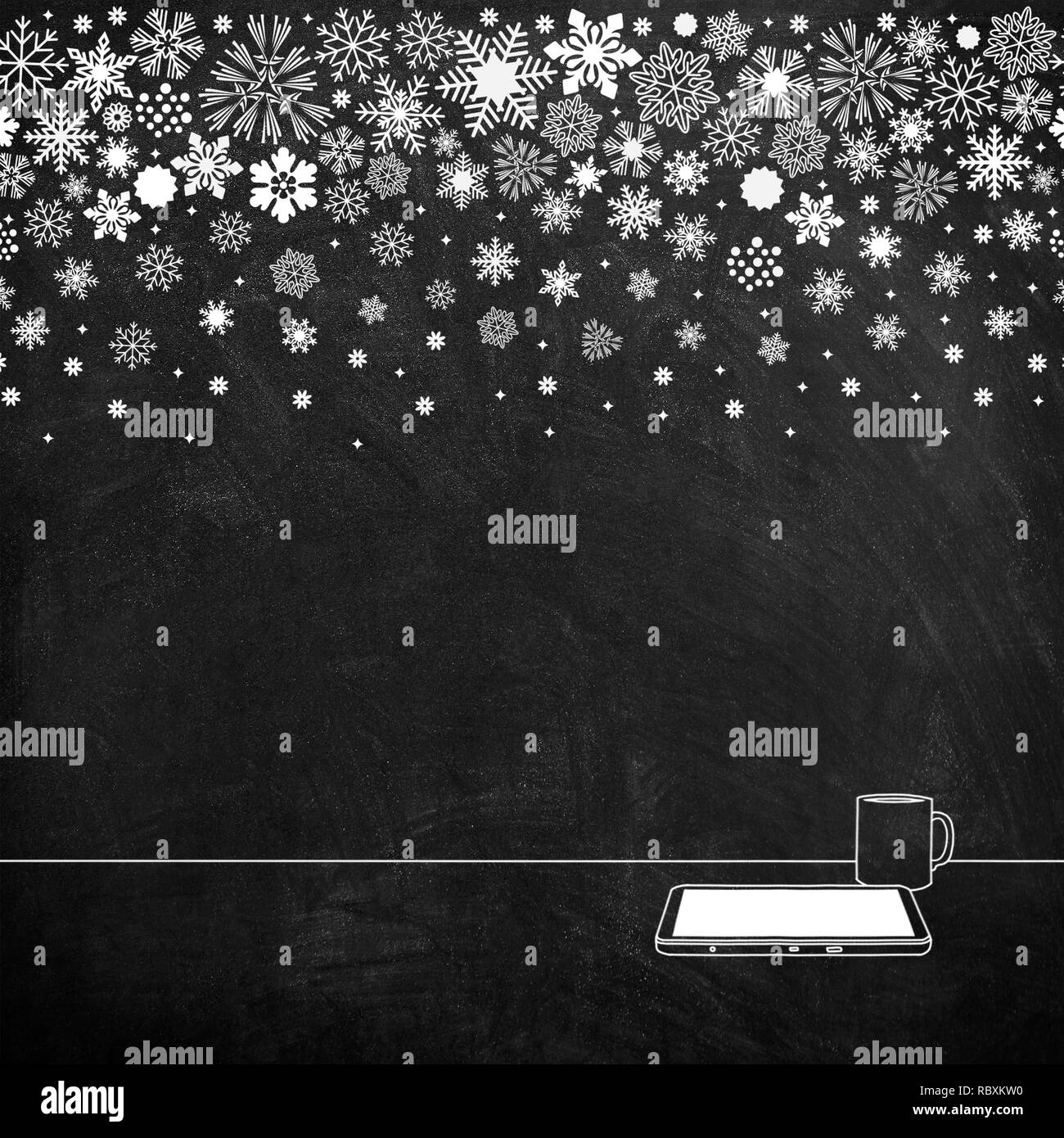 White chalk sketch drawing of snowflakes on blackboard background and tablet with mug Stock Photo