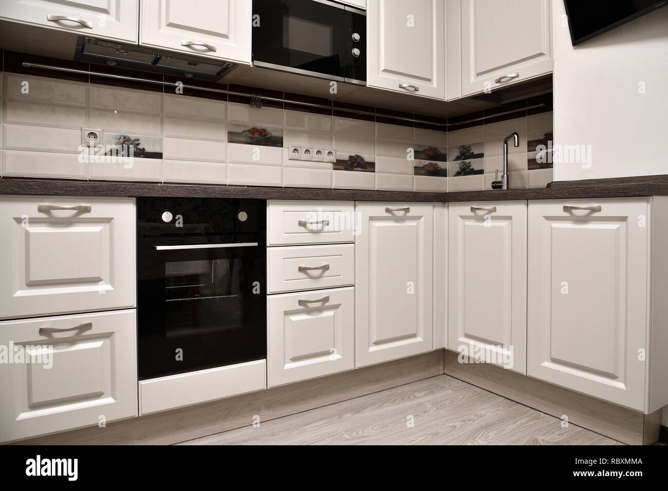 Beige kitchen with oven and a microwave Stock Photo