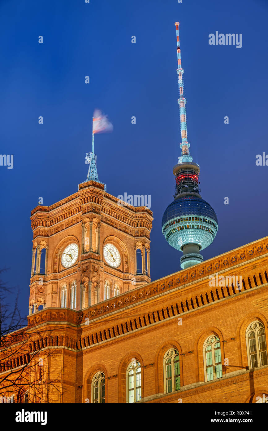 The famous Television Tower and the tower of the city hall in Berlin at night Stock Photo
