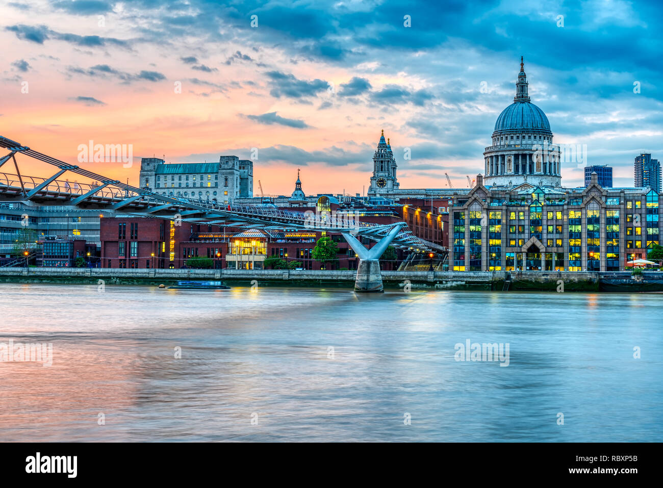 St. Paul's Cathedral and the Millennium Bridge  in London, UK, after sunset Stock Photo
